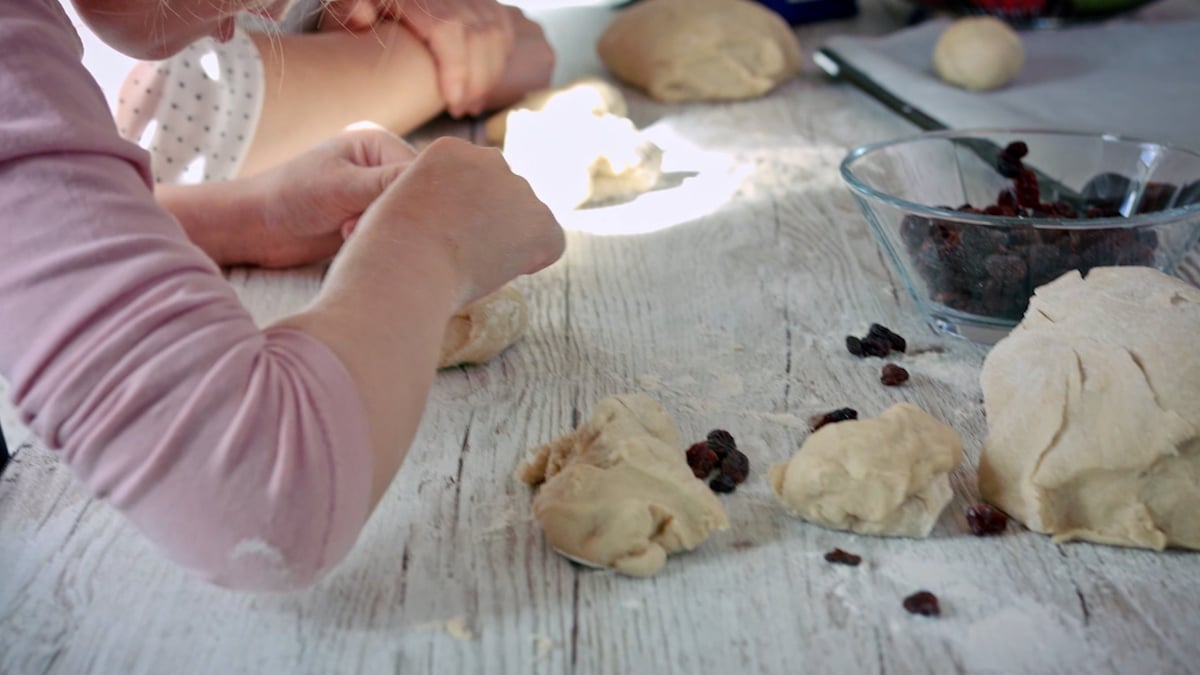 child is using its hands to handle baking