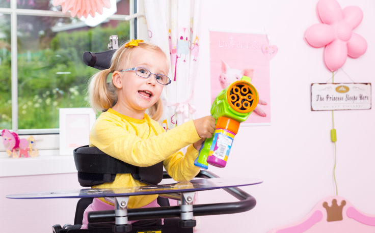Young girl plays with a water toy while standing in the Innowalk