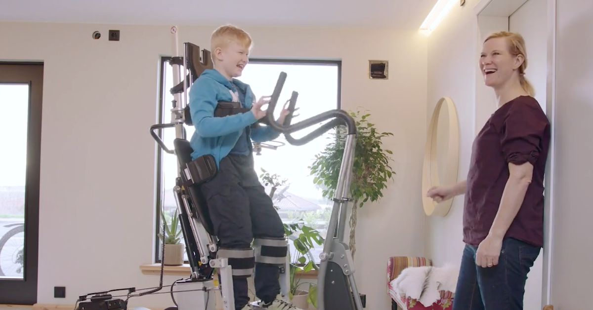 Young boy with Duchenne walking in his Innowalk as a assistive device.