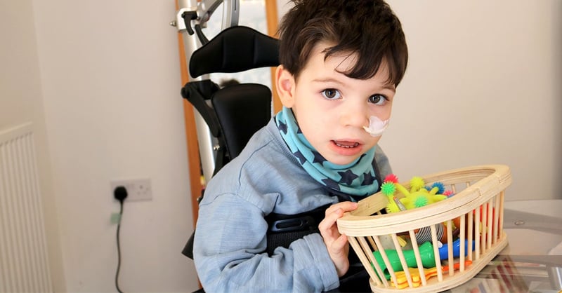 Oliver in his Innowalk while playing with toys