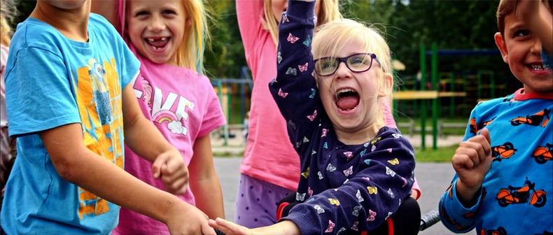 Young girl cheers with joy with friends