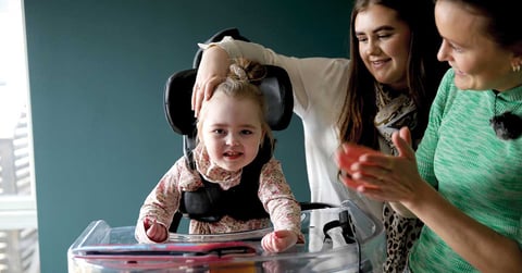 Young girl stands in her Innowalk while her head is supported