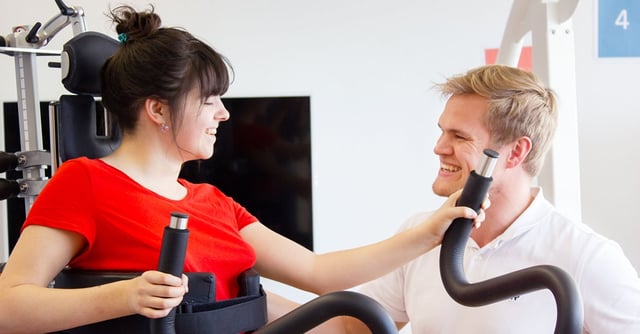 Woman walks in the Innowalk with supervision from her therapist