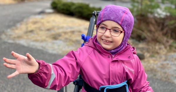 Young girl is out walking with support from Hibbot