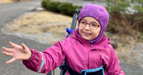 Young girl is out walking with support from Hibbot