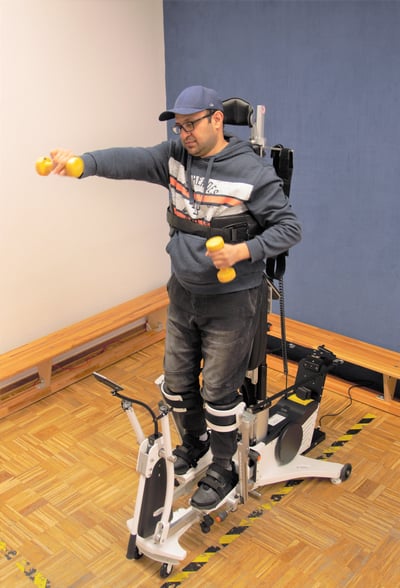 Man is training with weights in the Innowalk Pro