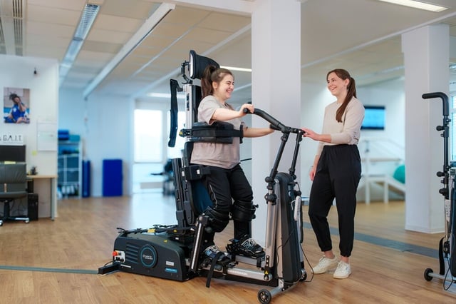 Patient standing in the Innowalk Pro in a clinical setting