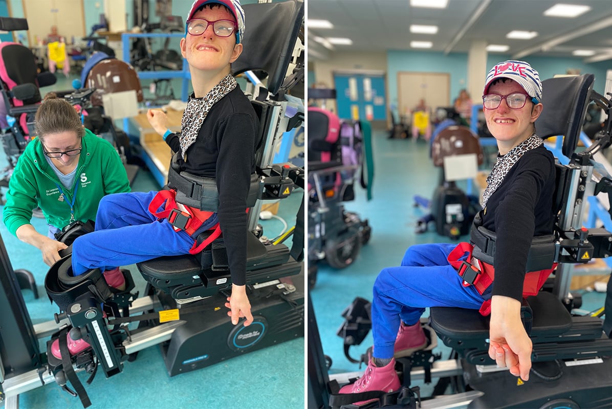 A smiling person seated in an Innowalk Pro during a therapy session.