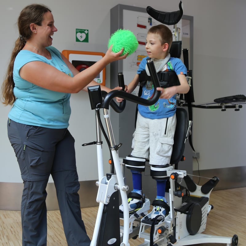 Boy in the Innowalk Pro playing with his therapist.
