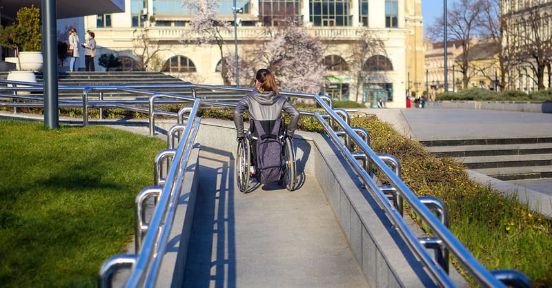 Woman in wheelchair on wheelchair ramp